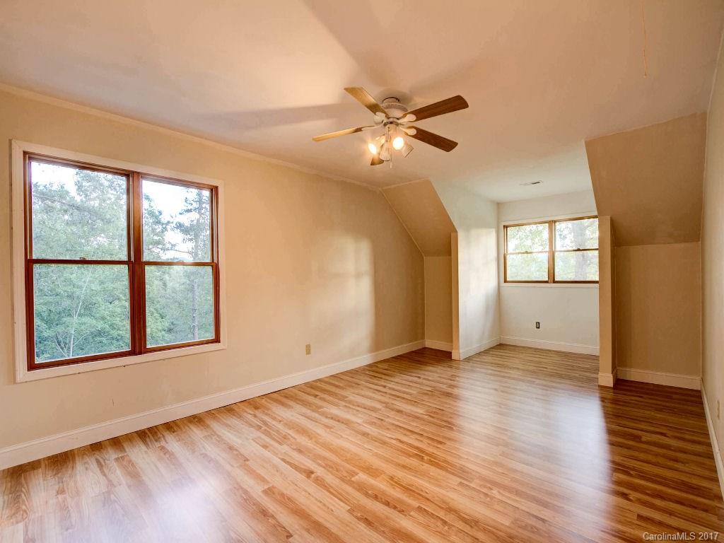 686 Fontana View Road, Unit 56 Bryson City, NC 28713 - Photo 7 of 24 a view of an empty room with a window and wooden floor