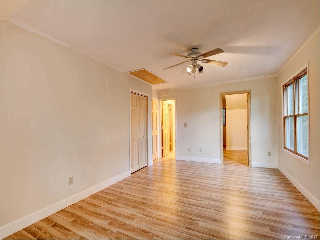 686 Fontana View Road, Unit 56 Bryson City, NC 28713 - Photo 8 of 24 wooden floor in an empty room with a window