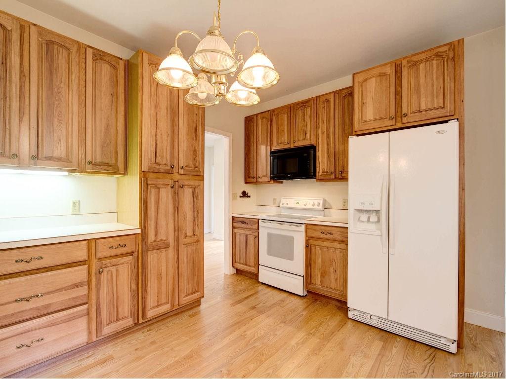 686 Fontana View Road, Unit 56 Bryson City, NC 28713 - Photo 10 of 24 a kitchen with a refrigerator a stove a microwave oven cabinets and wooden floor