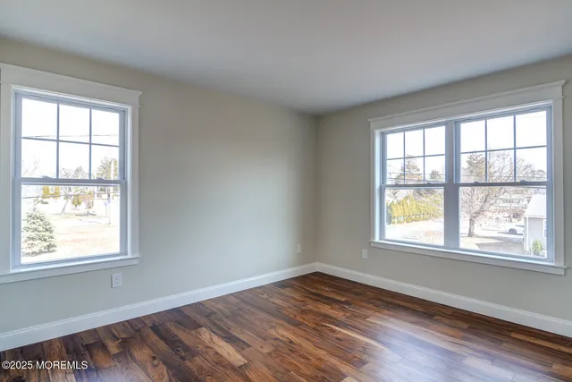 a view of a balcony with a floor to ceiling window next to a yard