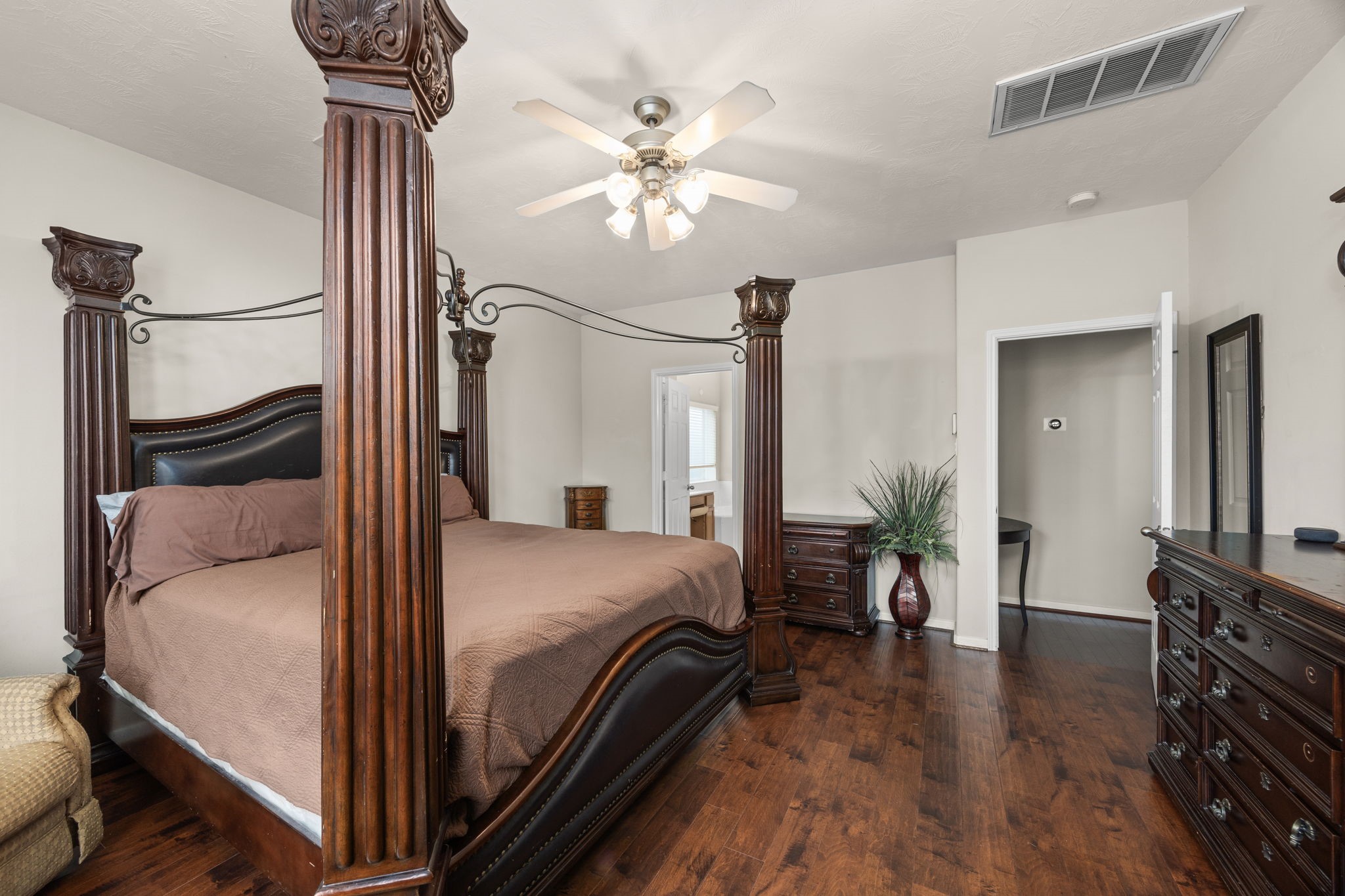 6719 Latchmore Lane Houston, TX 77049 - Photo 26 of 46 a bedroom with a bed and wooden floor