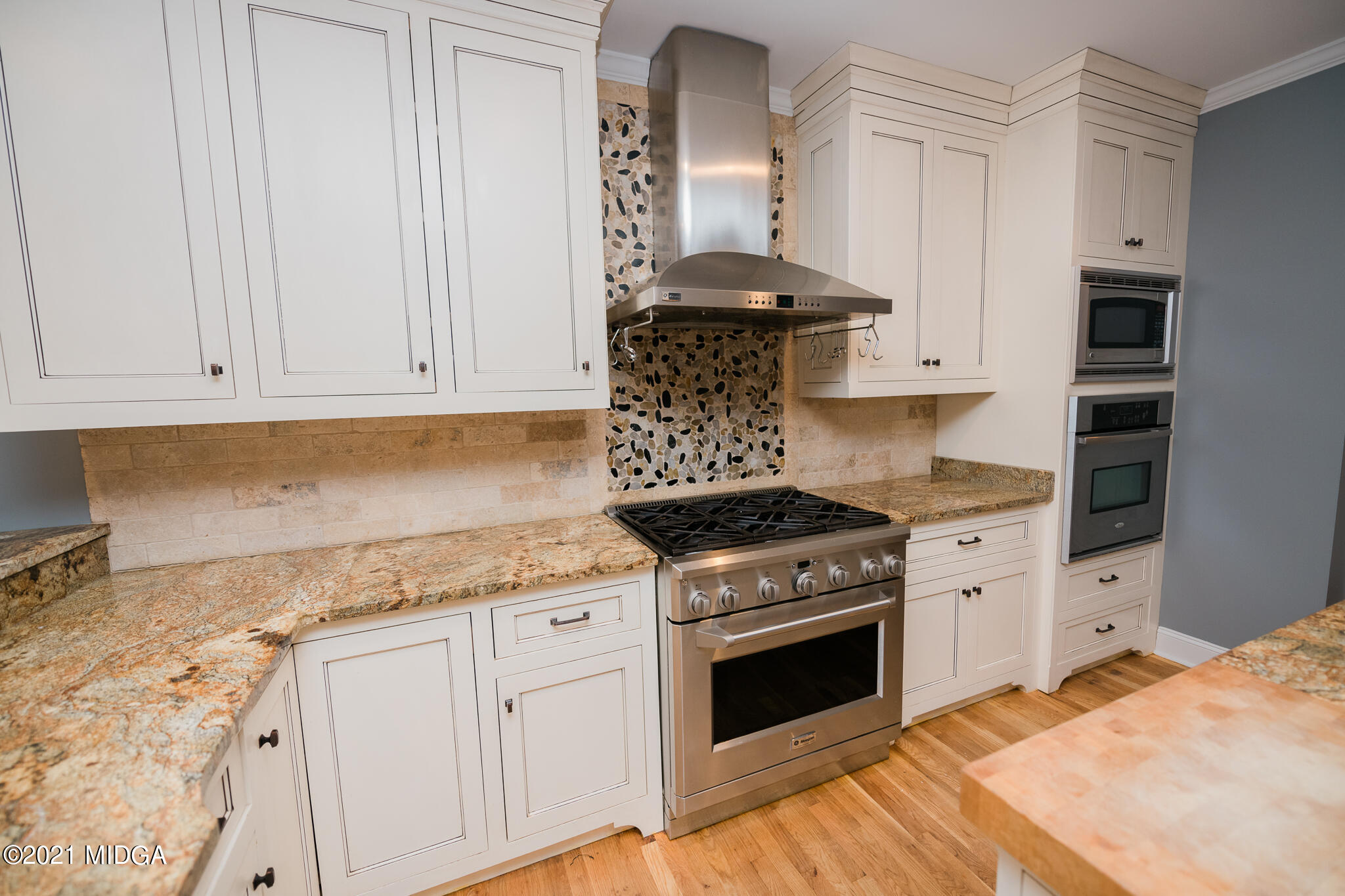 116 Hampton Ridge Road Macon, GA 31220 - Photo 16 of 77 a kitchen with granite countertop white cabinets and white appliances
