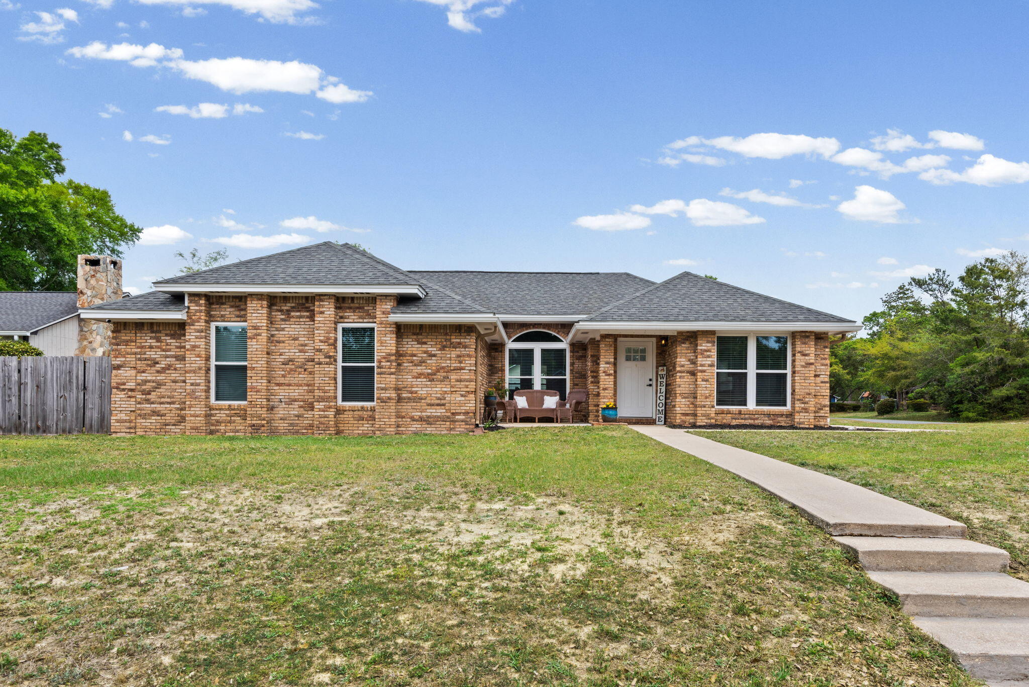 943 Ridgewood Way Niceville, FL 32578 - Photo 1 of 42 a front view of a house with a garden
