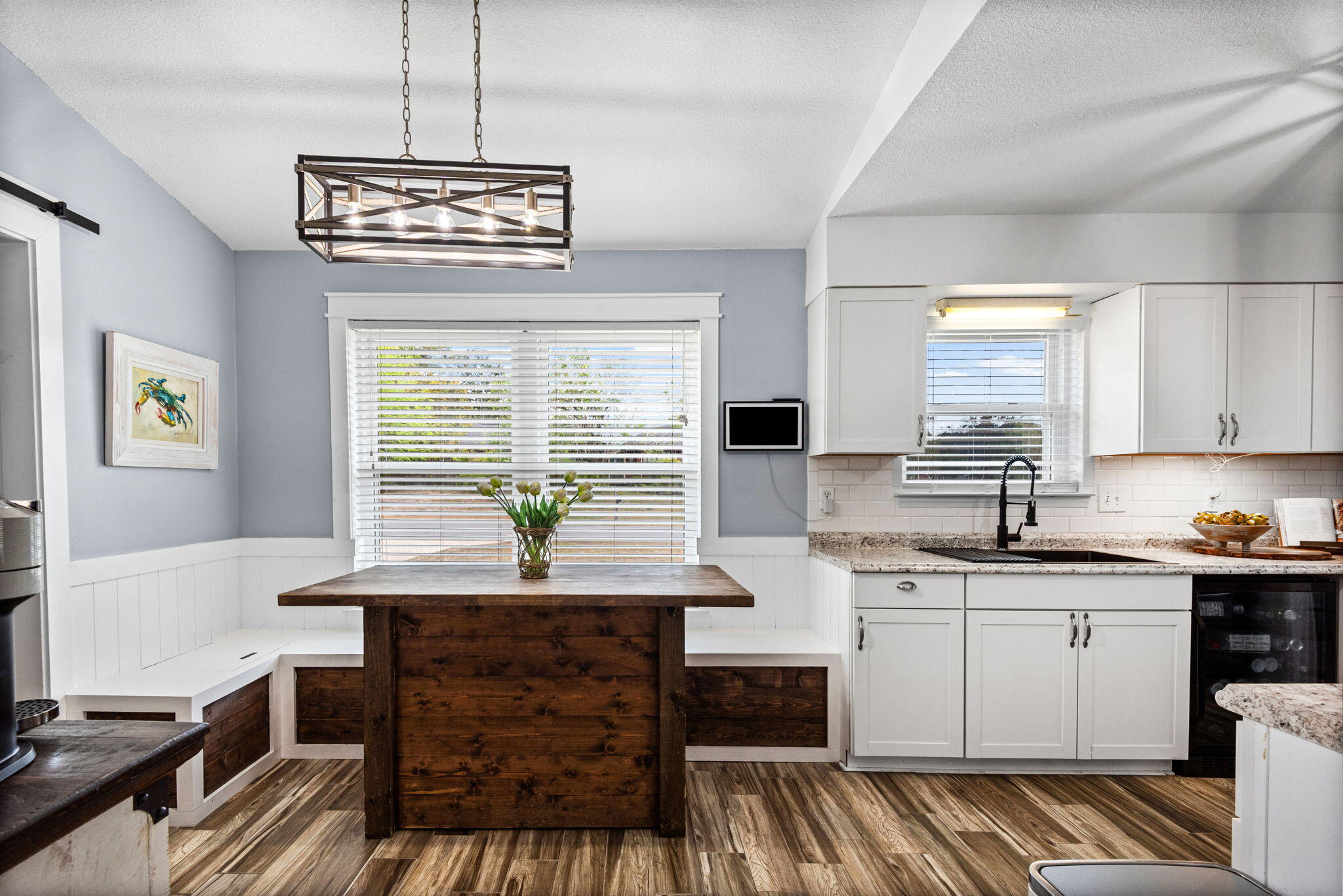 943 Ridgewood Way Niceville, FL 32578 - Photo 14 of 42 a kitchen with a chandelier windows and chairs
