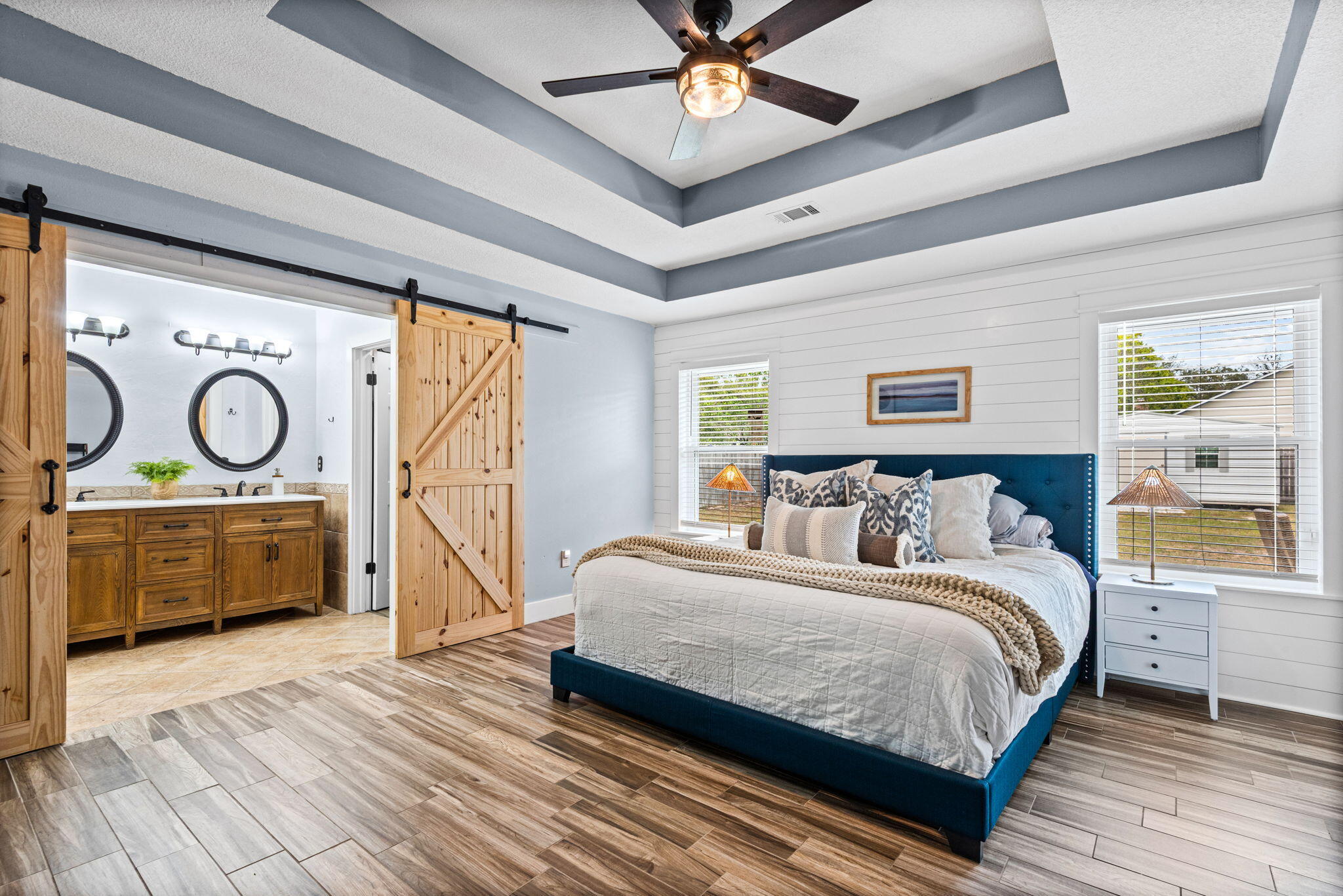 943 Ridgewood Way Niceville, FL 32578 - Photo 21 of 42 a bedroom with a bed and a chandelier
