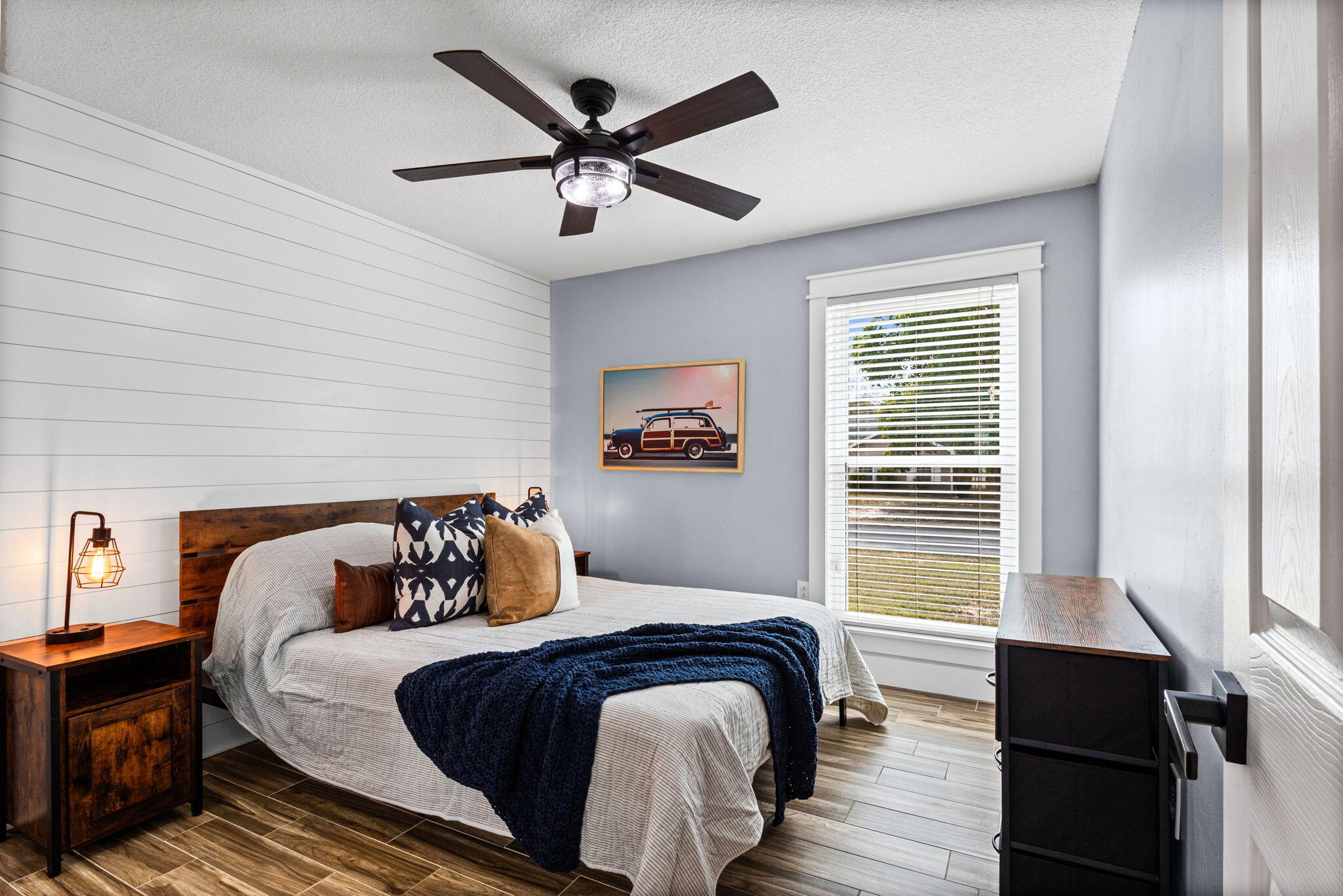 943 Ridgewood Way Niceville, FL 32578 - Photo 27 of 42 a bedroom with a bed and wooden floor