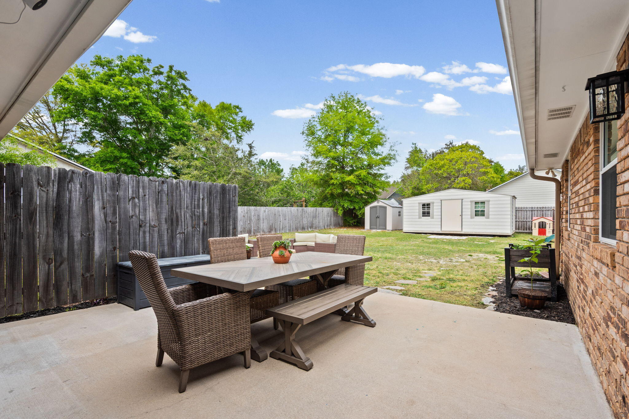 943 Ridgewood Way Niceville, FL 32578 - Photo 34 of 42 a backyard of a house with table and chairs