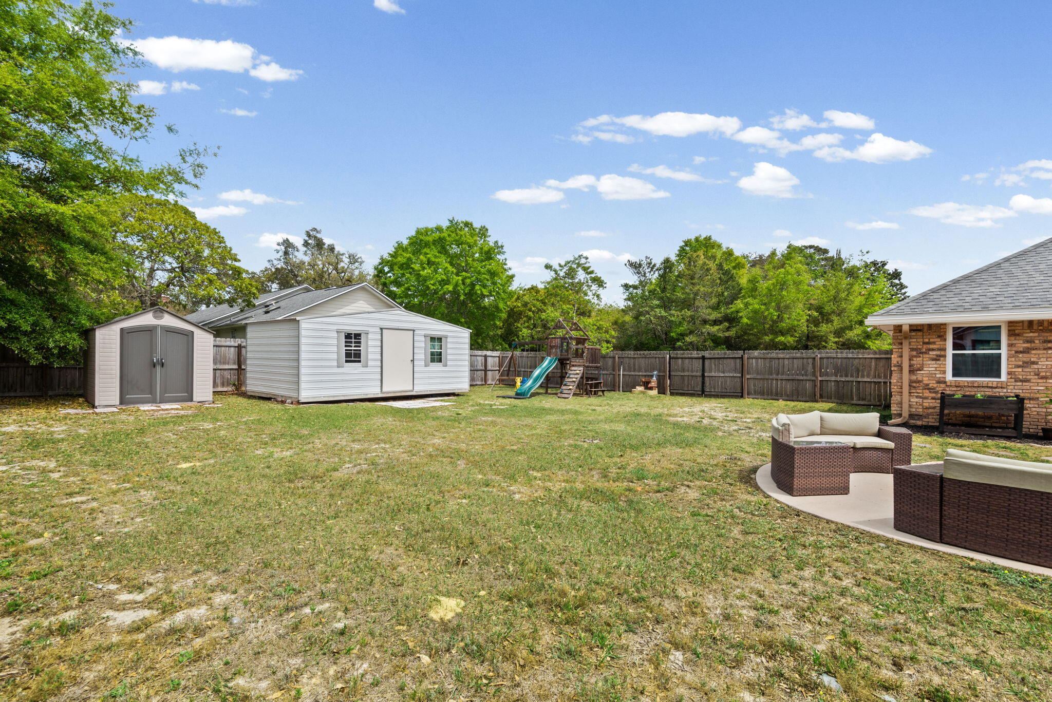 943 Ridgewood Way Niceville, FL 32578 - Photo 38 of 42 a backyard of a house with fire pit barbeque oven and outdoor seating