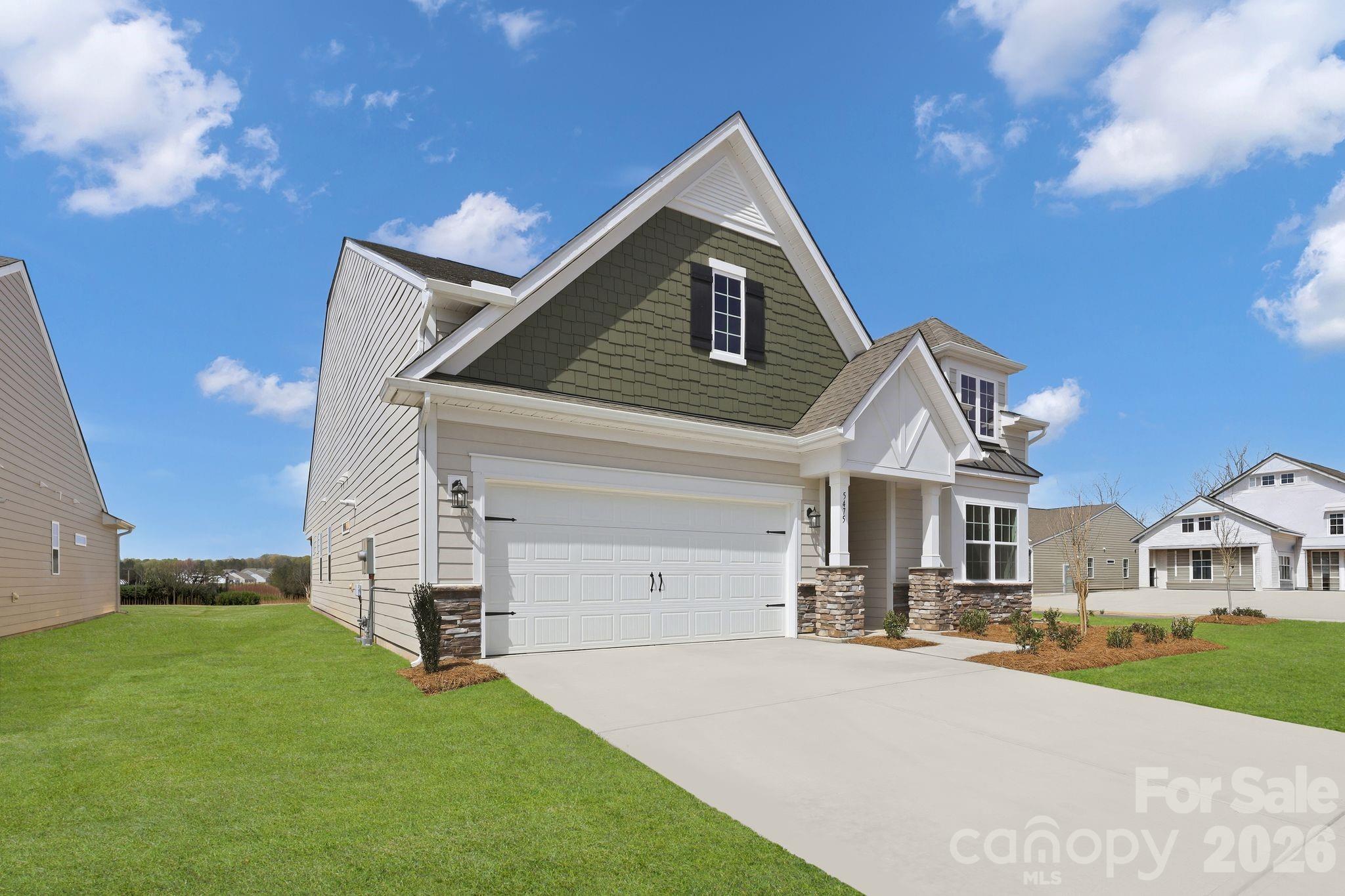 5475 Redbud Road, Unit 57 Lancaster, SC 29720 - Photo 5 of 30 a front view of a house with a yard and garage