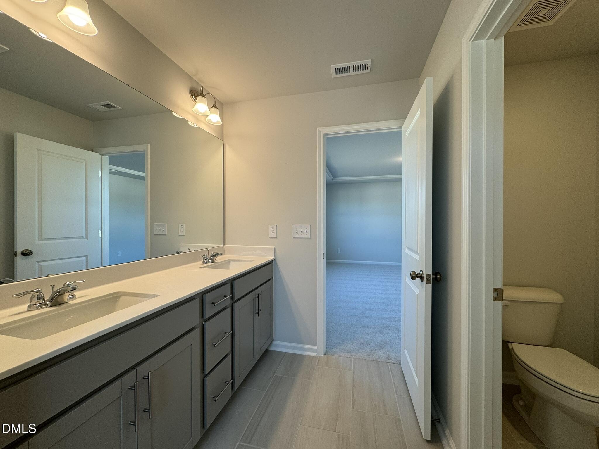 2509 Salt River Lane Raleigh, NC 27616 - Photo 27 of 34 a bathroom with a sink a toilet and shower