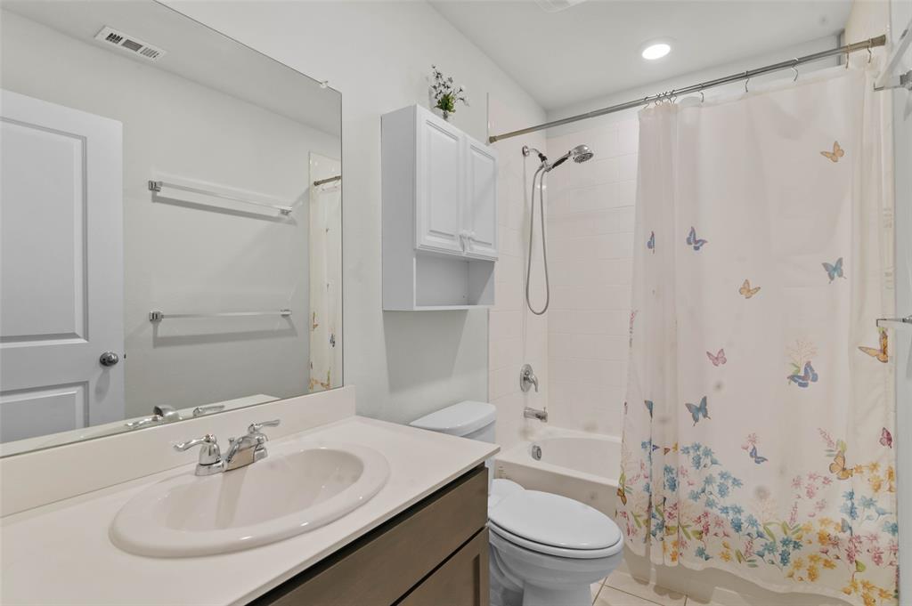 409 Wilson Way Denton, TX 76207 - Photo 22 of 33 Full bathroom featuring a single vanity with an integrated sink, a large wall-mounted mirror, a tub/shower combination, and recessed lighting