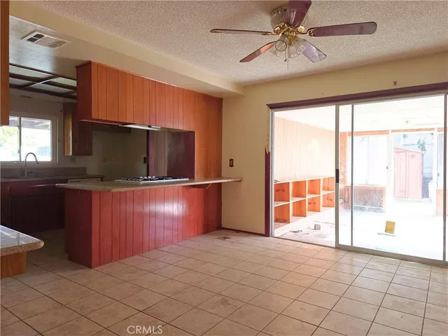 a kitchen with granite countertop a sink and a refrigerator