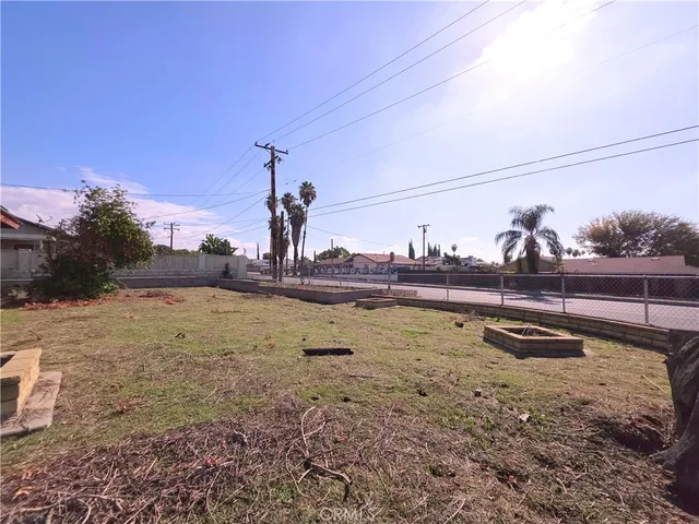 a view of a house with a yard and tree s