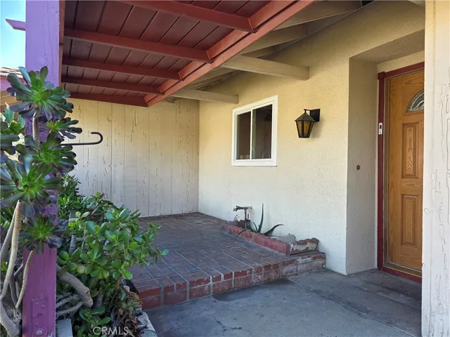 a bedroom with a bed and a potted plant