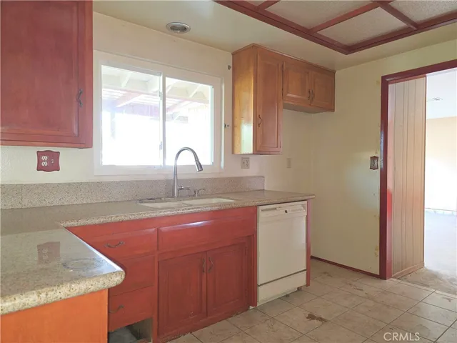 a kitchen with stainless steel appliances granite countertop a sink and a window