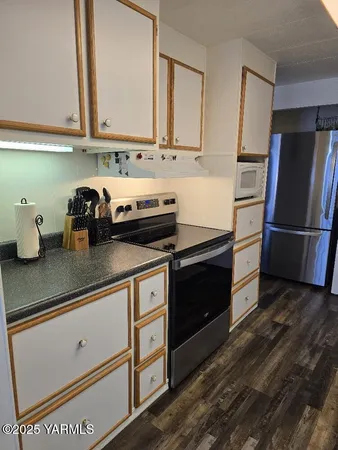 a kitchen with stainless steel appliances granite countertop a refrigerator and a stove