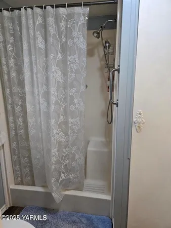 a bathroom with a glass shower door