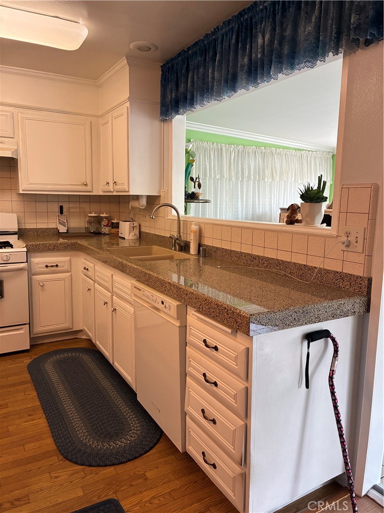 10456 Hamilton Street Rancho Cucamonga, CA 91701 - Photo 11 of 17 a kitchen with a sink a stove and cabinets