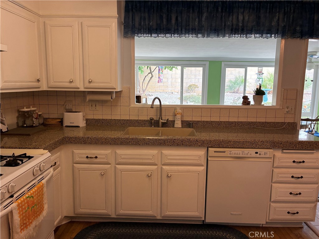 10456 Hamilton Street Rancho Cucamonga, CA 91701 - Photo 12 of 17 a kitchen with granite countertop a sink and a stove