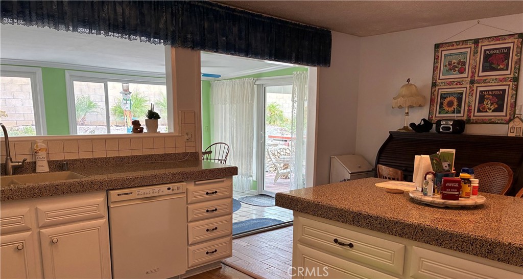 10456 Hamilton Street Rancho Cucamonga, CA 91701 - Photo 13 of 17 a kitchen with a granite countertop sink a stove and a window