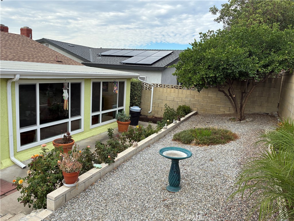 10456 Hamilton Street Rancho Cucamonga, CA 91701 - Photo 15 of 17 a view of a house with backyard sitting area and garden