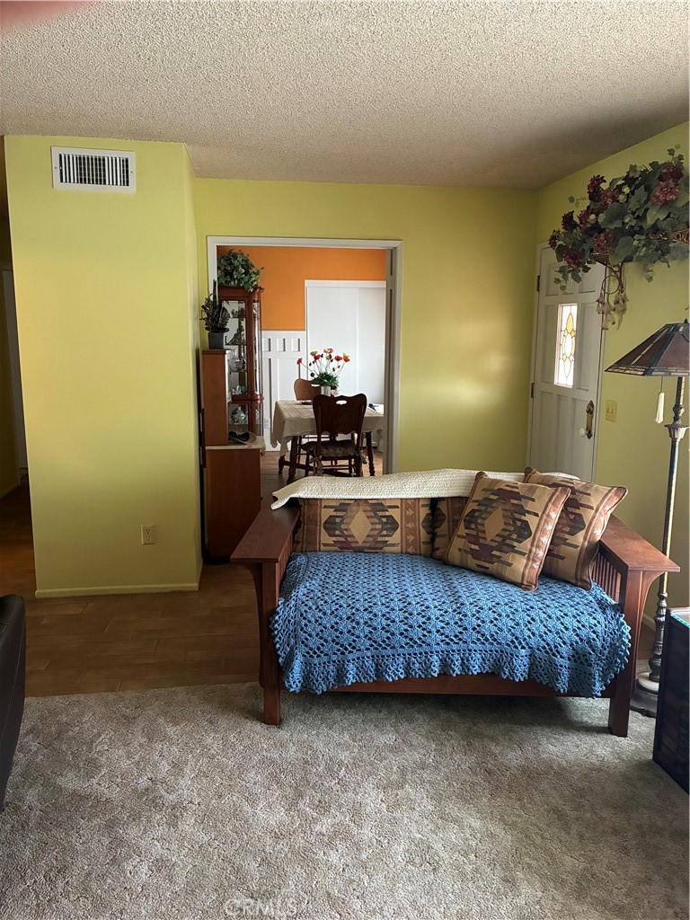 10456 Hamilton Street Rancho Cucamonga, CA 91701 - Photo 5 of 17 a large bedroom with a bed and wooden floor