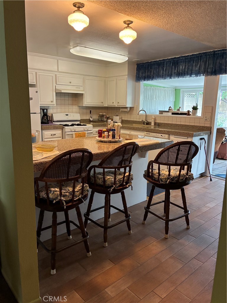 10456 Hamilton Street Rancho Cucamonga, CA 91701 - Photo 8 of 17 a dinning room dining table chairs and a kitchen view