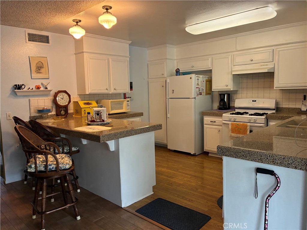 10456 Hamilton Street Rancho Cucamonga, CA 91701 - Photo 10 of 17 a kitchen with a sink refrigerator and cabinets