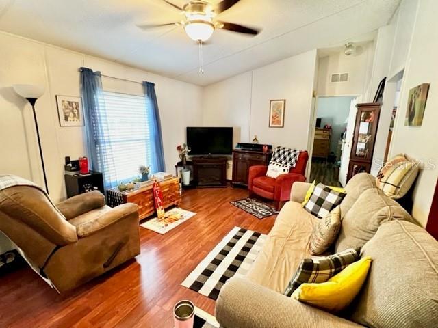 6669 Northwest 36th Lane Bell, FL 32619 - Photo 15 of 39 a living room with furniture fireplace and a flat screen tv