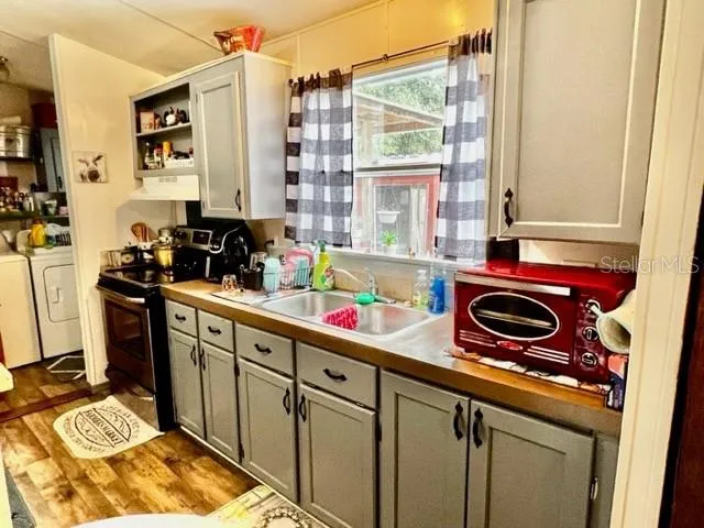 a kitchen with stove and cabinets
