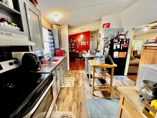 a kitchen with stainless steel appliances granite countertop a refrigerator and microwave