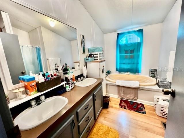 6669 Northwest 36th Lane Bell, FL 32619 - Photo 26 of 39 a room with furniture a rug a sink and a mirror