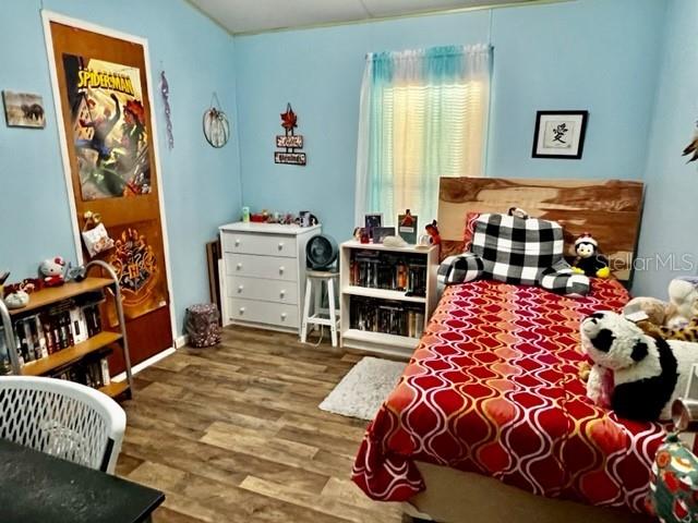 6669 Northwest 36th Lane Bell, FL 32619 - Photo 27 of 39 a bedroom with a bed and a bookshelf