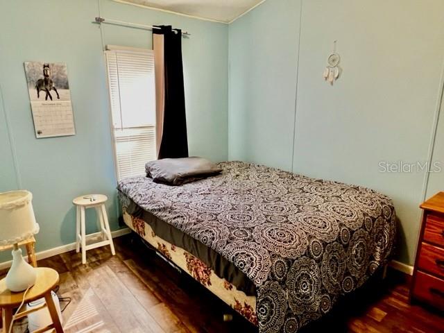 6669 Northwest 36th Lane Bell, FL 32619 - Photo 29 of 39 a bedroom with a bed and chair