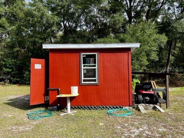 6669 Northwest 36th Lane Bell, FL 32619 - Photo 33 of 39 a backyard of a house with yard and trampoline