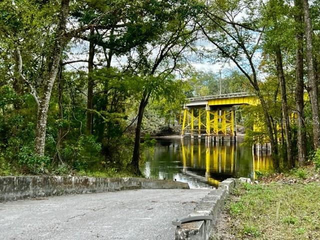 6669 Northwest 36th Lane Bell, FL 32619 - Photo 38 of 39 a backyard of a house with a lake view