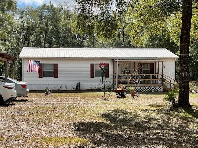 6669 Northwest 36th Lane Bell, FL 32619 - Photo 4 of 39 a view of a house with backyard porch