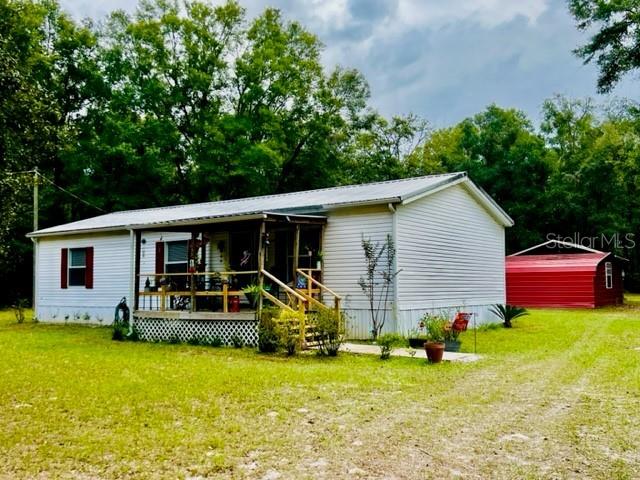 6669 Northwest 36th Lane Bell, FL 32619 - Photo 5 of 39 a front view of house with yard and seating area