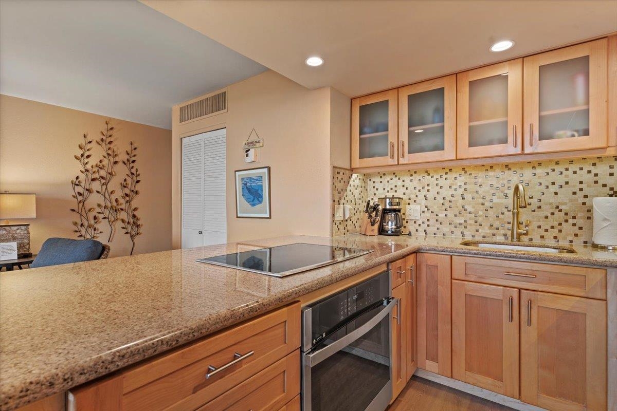 36 South Kihei Road, Unit 103 Kihei, HI 96753 - Photo 20 of 37 a kitchen with granite countertop a sink and cabinets