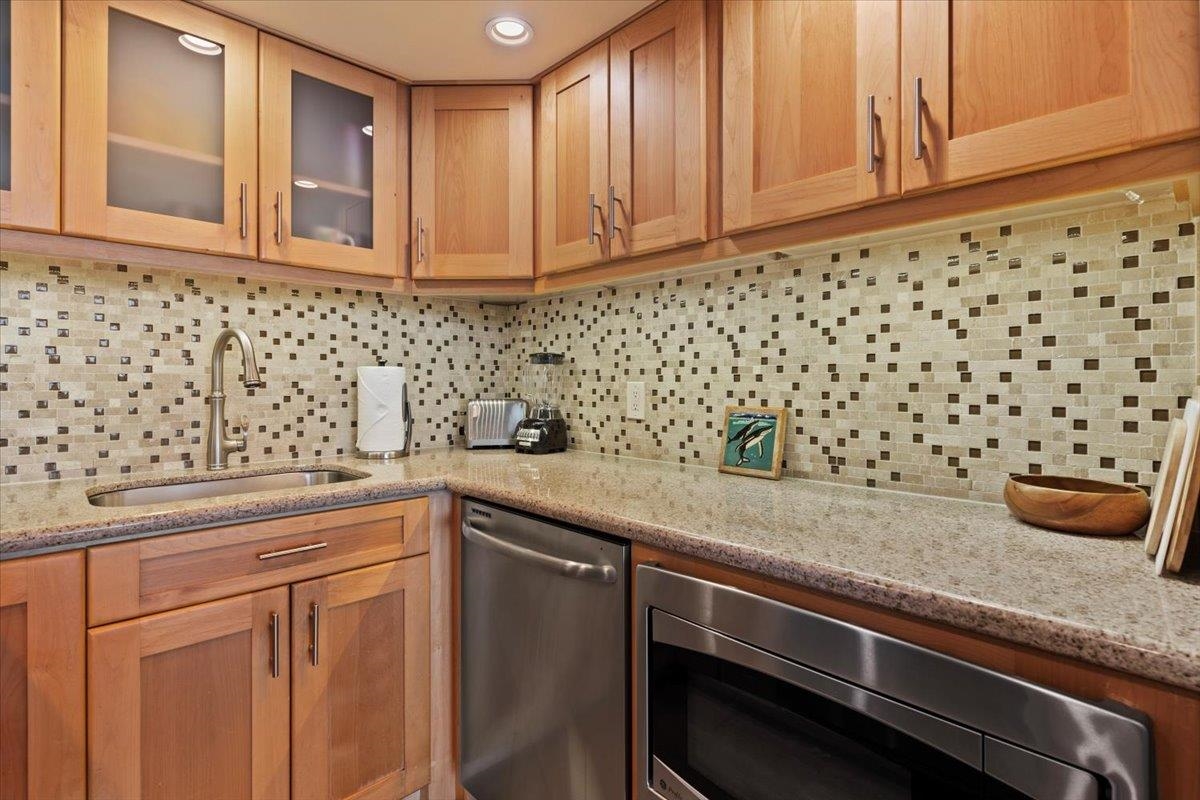 36 South Kihei Road, Unit 103 Kihei, HI 96753 - Photo 21 of 37 a kitchen with a sink and cabinets