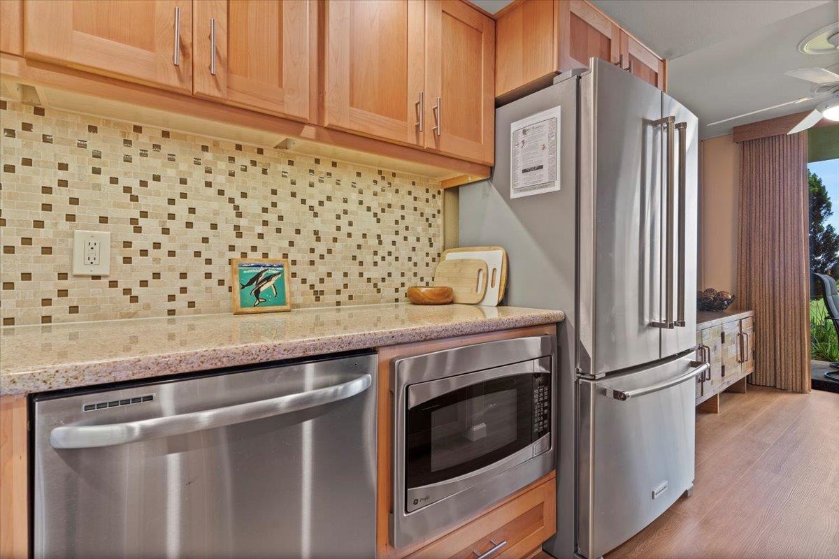 36 South Kihei Road, Unit 103 Kihei, HI 96753 - Photo 22 of 37 a kitchen with stainless steel appliances granite countertop a refrigerator and a stove