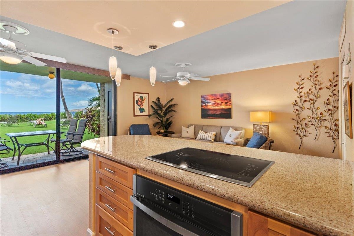 36 South Kihei Road, Unit 103 Kihei, HI 96753 - Photo 23 of 37 a kitchen with a sink and a large window