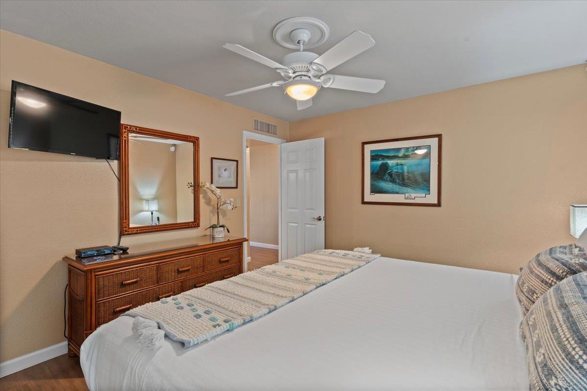 36 South Kihei Road, Unit 103 Kihei, HI 96753 - Photo 26 of 37 a bedroom with a bed and a flat screen tv