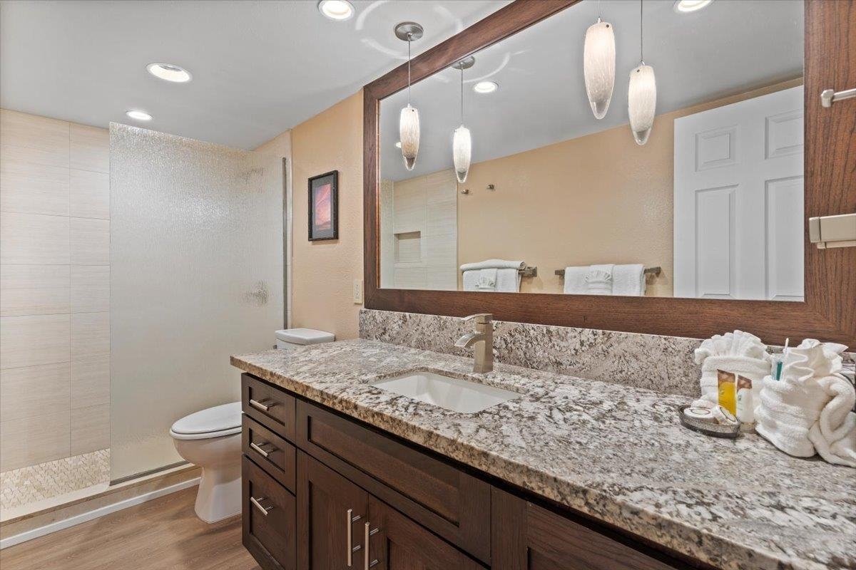 36 South Kihei Road, Unit 103 Kihei, HI 96753 - Photo 29 of 37 a bathroom with a granite countertop sink a toilet and a mirror