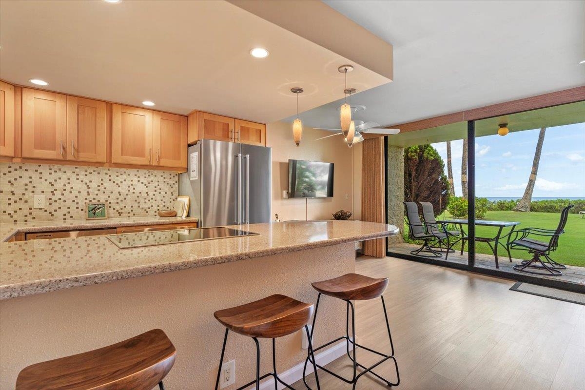 36 South Kihei Road, Unit 103 Kihei, HI 96753 - Photo 9 of 37 a kitchen with stainless steel appliances kitchen island granite countertop a refrigerator and a sink