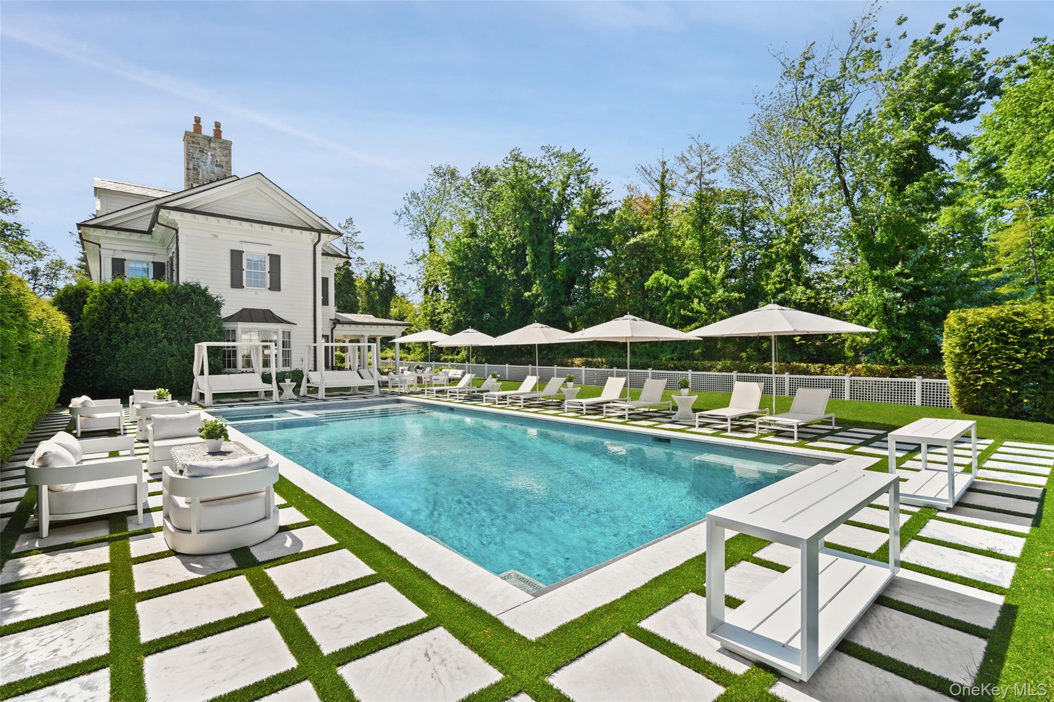 27 Murray Hill Road Scarsdale, NY 10583 - Photo 22 of 29 a view of a patio with table and chairs under an umbrella