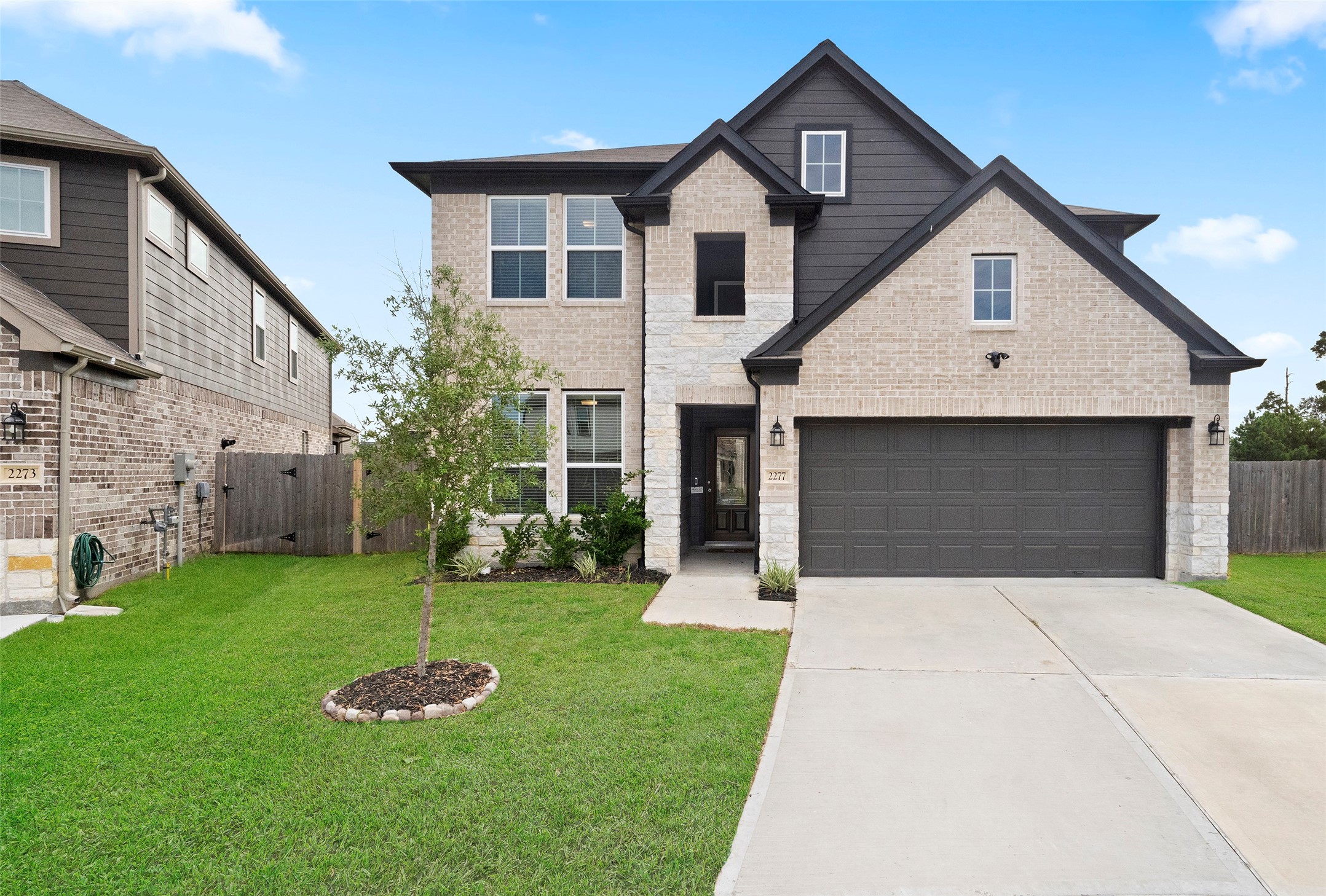 a front view of a house with a yard and garage