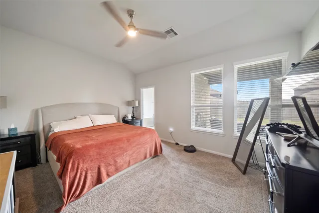 a bedroom with two beds and a window