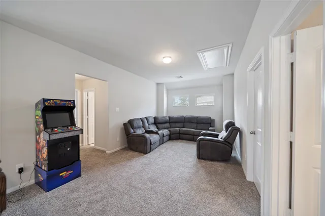 a living room with furniture a flat screen tv and dresser