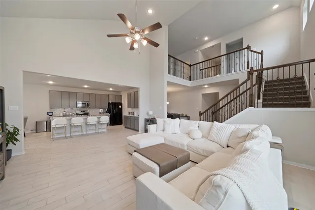 a living room with furniture and kitchen view